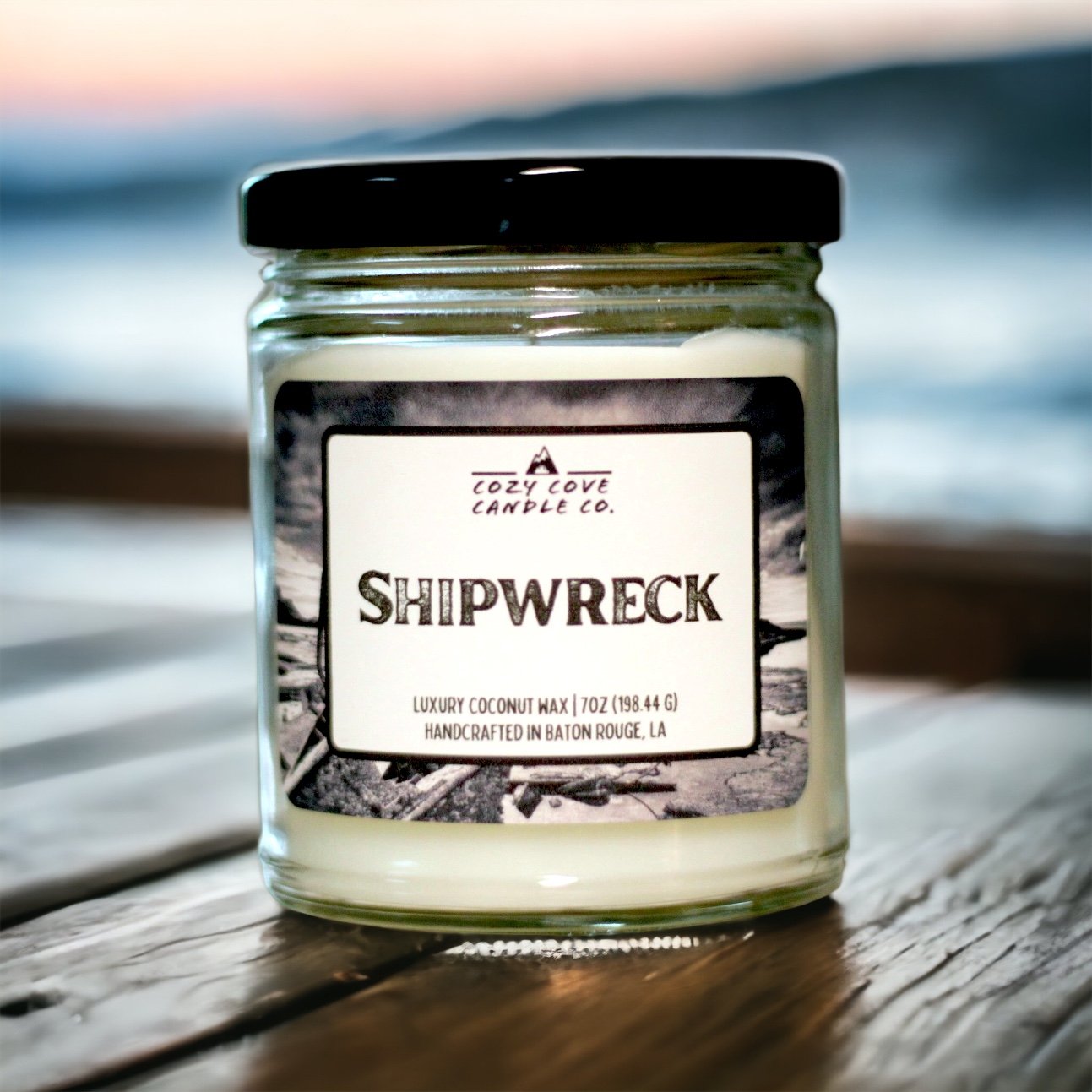 Shipwreck | Scented Candle 1 shipwreck candle sitting on a deck in front of water