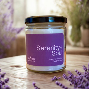 serenity and soul candle on a table with lavender botanical pieces around it
