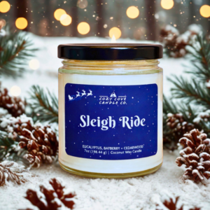 sleigh ride candle with snowy winter background